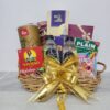 Gin Thye Celebration Gourmet Hamper filled with nuts, chocolates, pineapple tart, and drinks in a bamboo basket