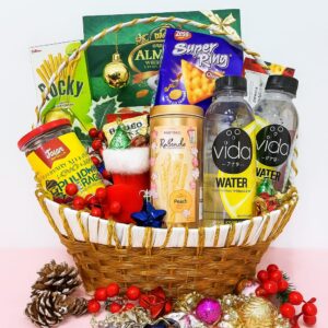 Gin Thye Festive Indulgence Hamper filled with snacks, chocolates, nuts, and drinks in a golden basket
